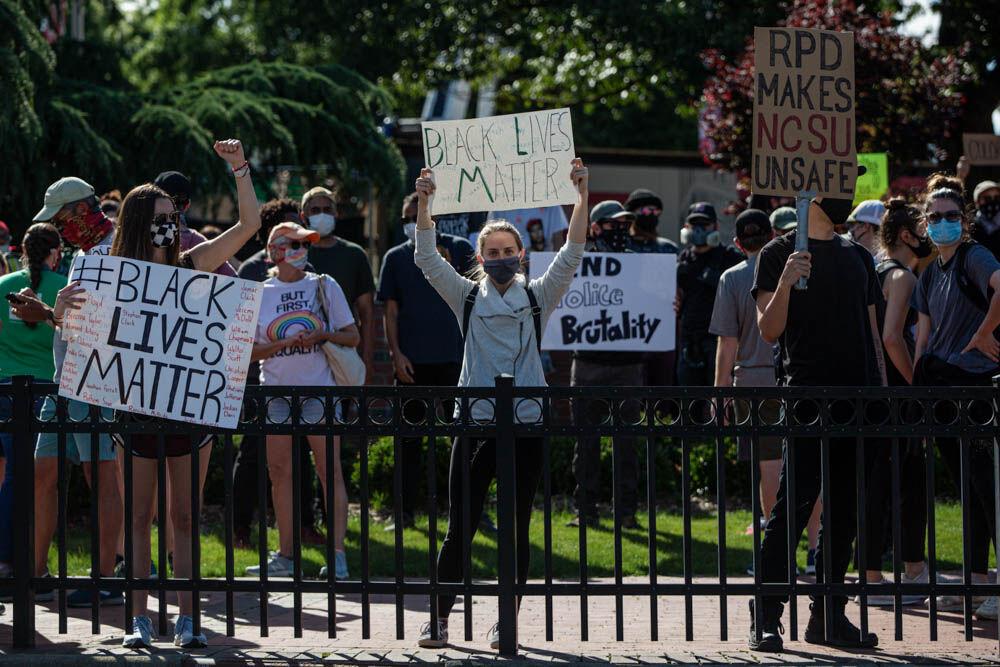 Protesters stand in front of the Memorial Belltower before peacefully marching down towards Downtown Raleigh on Monday, June 1, 2020 at the NC State Memorial Belltower. The protesters marched down Hillsborough street to the capitol building, then the governors mansion, before finally returning back the the Belltower before the start of the citywide curfew. The mayor of Raleigh had issued a citywide curfew until further notice after the unrest caused by the riots over the weekend. The curfew is in effect from 8 P.M. till 5 A.M. the next morning. The protest on June 1 was completely peaceful through its entirety.
