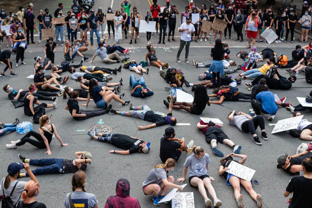 Protesters lie down in front of the capitol building performing a die-in protest to outline the deaths of individuals through police brutality Tuesday, June 2, 2020 in Downtown Raleigh. This peaceful protest was organized by NCBORN and was the second day of peaceful protesting in Raleigh. Raleigh has been under a citywide curfew since June 1 that lasts from 8 P.M. through 5 A.M.