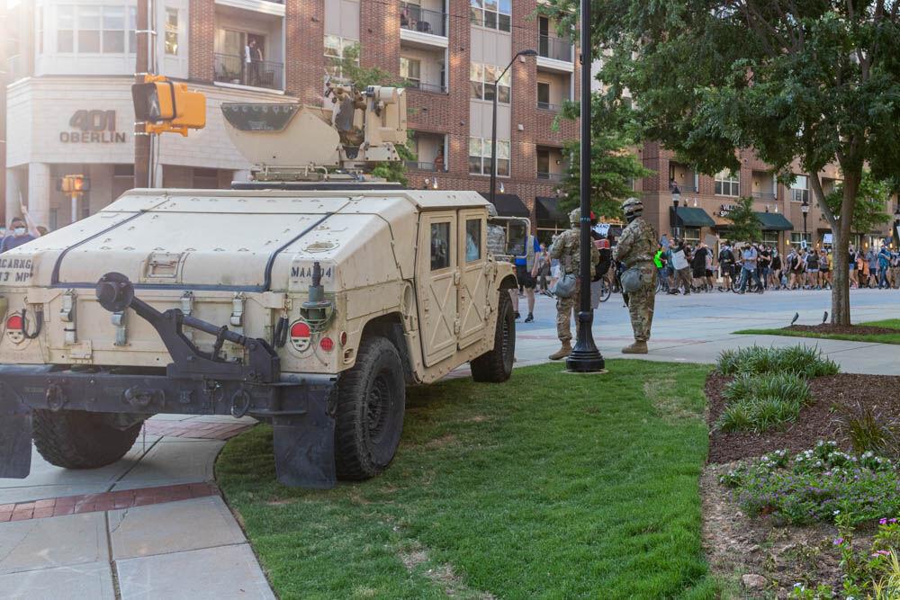 Protesters march down Oberlin road as the National Guard watches on Thursday, June 4, 2020 in Cameron Village.