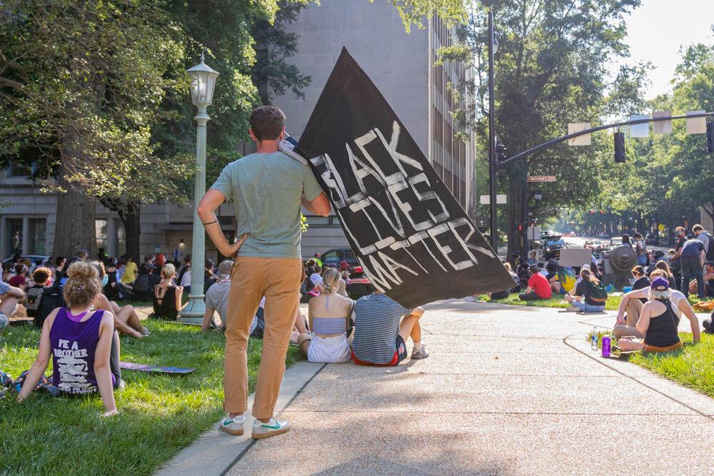 Protesters gather and sit at the capitol on Thursday, June 4, 2020 in Downtown Raleigh. Thursday marked the fourth day of non-violent protests and the fourth day of curfew, though the curfew was pushed back and started at 10 P.M. on Thursday.