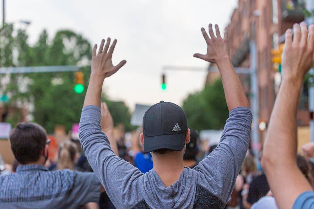 Protesters raise their arms up while chanting &#8220;hands up, don&#8217;t shoot&#8221; on Tuesday, June 2, 2020 in Downtown Raleigh. Protesters marched from the Duke Energy Center to the State Capitol, the governors mansion and then back. Tuesday marked the second day of non-violent protesting.