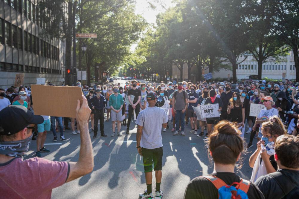 Protesters surround and listen to a speaker in front of the capitol building on Monday, June 1, 2020 in downtown Raleigh. The protest on June 1 was completely peaceful compared to the weekend that ended in riots. Protesters marched around Downtown Raleigh and back to the memorial Belltower, all before the start of a city wide curfew at 8 P.M. and lasting through 5 A.M. the next morning. The protest on June 1 was completely peaceful through its entirety.