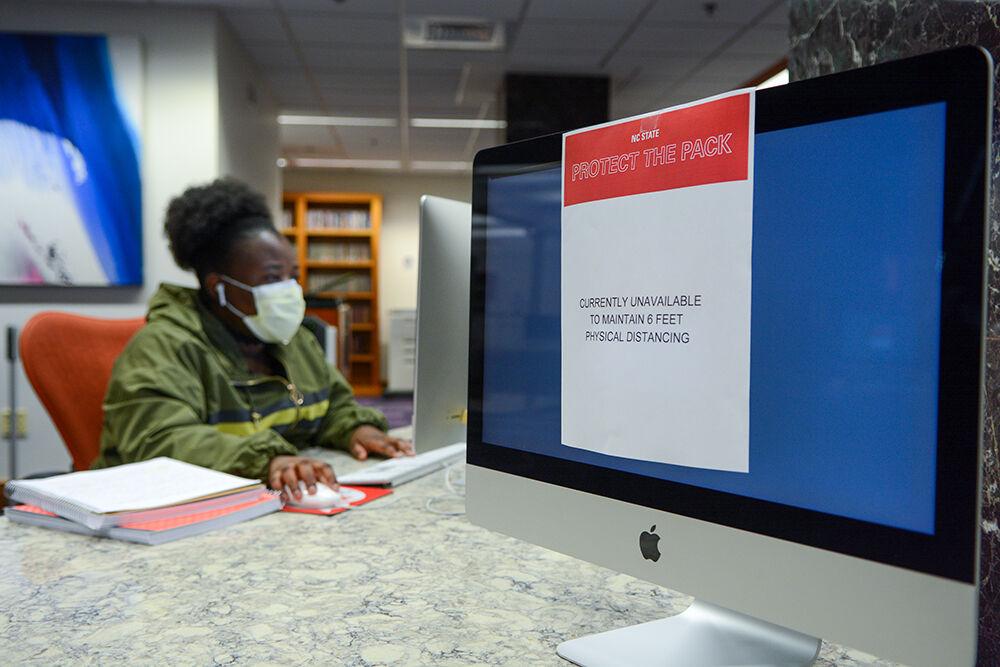 Joy Kibobi, first-year studying political science, works at the computer at D.H. Hill Library on Thursday, Aug 20, 2020. Students were required to stay 6 feet apart while studying in D.H. Hill Library.