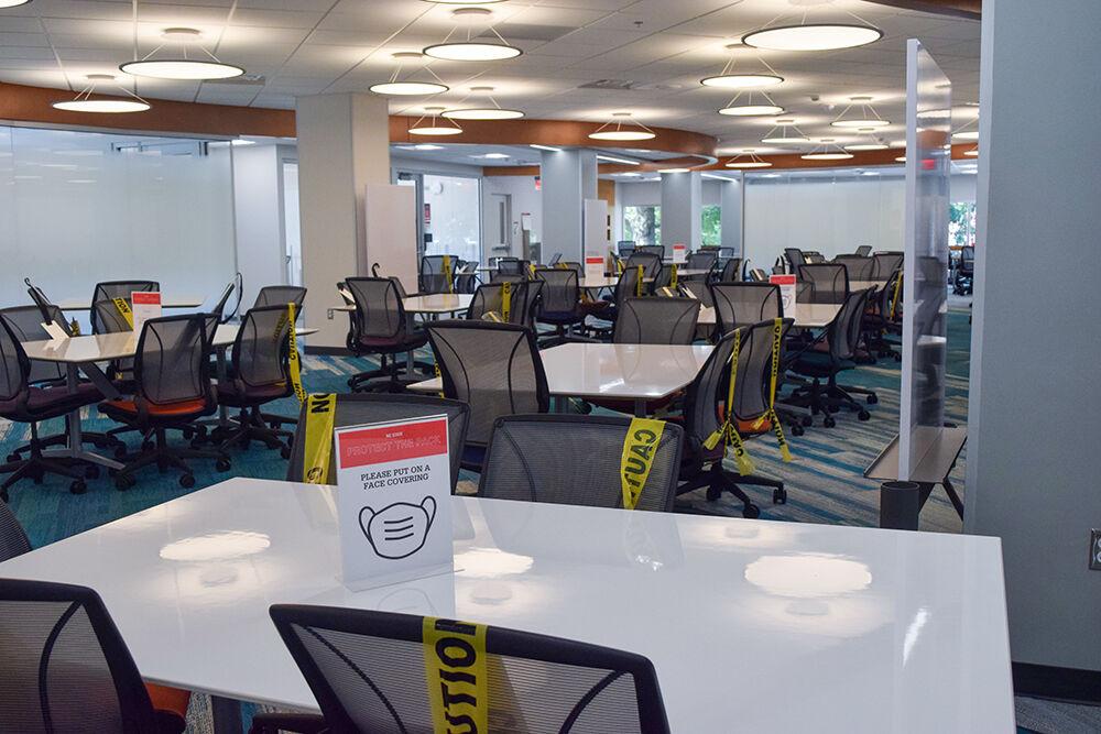 The newly-opened second floor of D.H. Hill Library has adjusted the desk area for COVID. On Saturday, Aug. 22, 2020, many caution-taped chairs and mask reminders were observed.