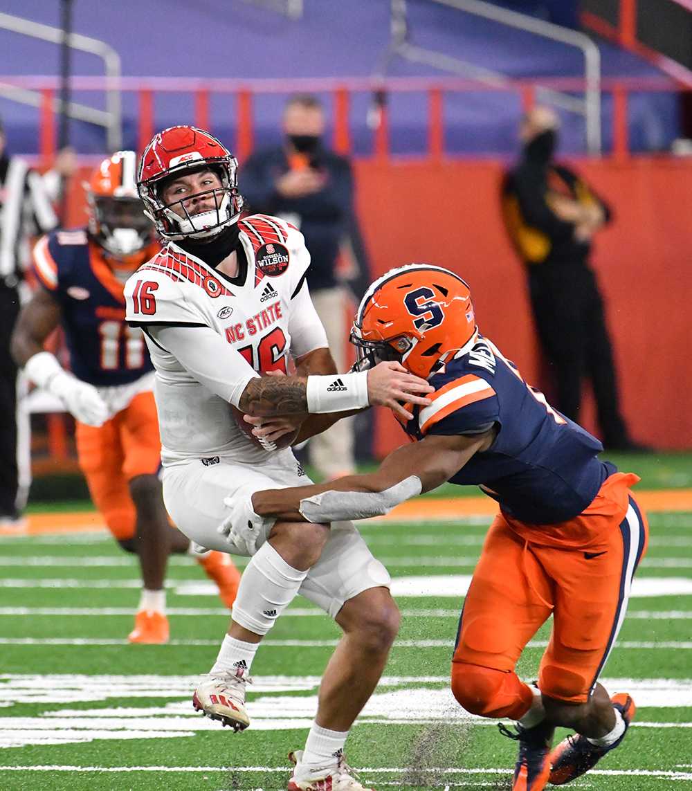 Nov 28, 2020; Syracuse, New York, USA;North Carolina State Wolfpack quarterback Bailey Hockman (16) is sacked by Syracuse Orange defensive back Ifeatu Melifonwu (2) in the second quarter at the Carrier Dome. Mandatory Credit: Mark Konezny-USA TODAY Sports
