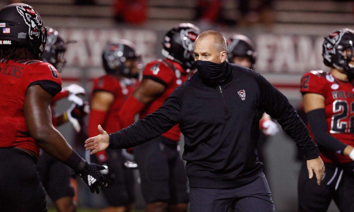 N.C. State head coach Dave Doeren encourages Terrell Dawkins (0) during warmups before N.C. State&#8217;s game against Florida State at Carter-Finley Stadium in Raleigh, N.C., Saturday, Nov. 14, 2020.
