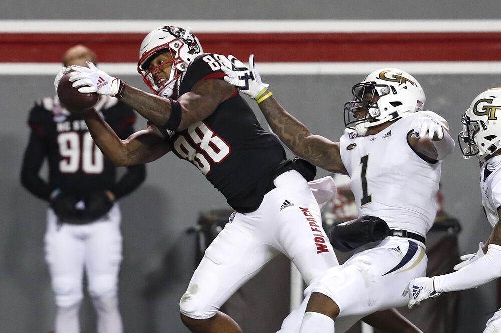 N.C. State wide receiver Devin Carter (88) makes the reception as Georgia Tech defensive back Juanyeh Thomas (1) defends during the first half of N.C. State&#8217;s game against Georgia Tech at Carter-Finley Stadium in Raleigh, N.C., Saturday, Dec. 5, 2020.