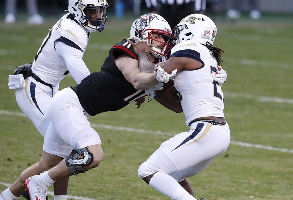 N.C. State linebacker Payton Wilson (11) tackles Georgia Tech running back Jordan Mason (27) for a loss during the first half of N.C. State&#8217;s game against Georgia Tech at Carter-Finley Stadium in Raleigh, N.C., Saturday, Dec. 5, 2020.