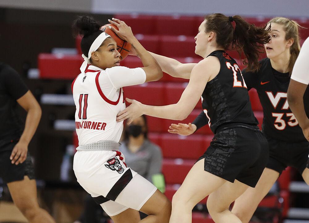 N.C. State's Jakia Brown-Turner (11) keeps the ball from Virginia Tech's Cayla King (22) during the first half of N.C. State&#8217;s game against Virginia Tech at Reynolds Coliseum in Raleigh, N.C., Sunday, January 24, 2021.