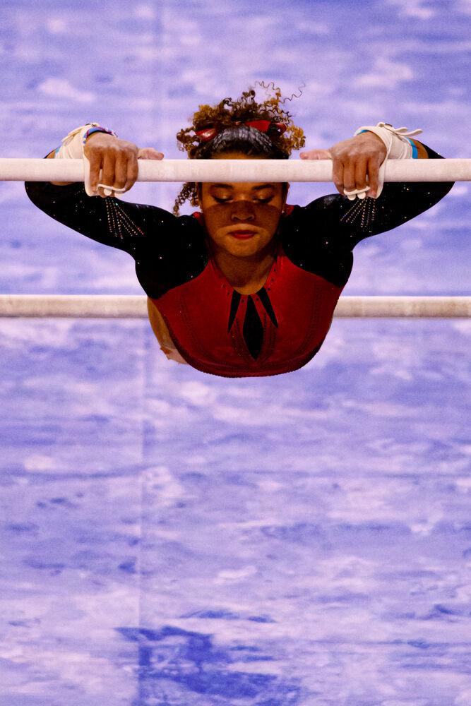 Freshman Carina Jordan performs on the uneven bars on Saturday, March 13, 2021 at Reynolds Coliseum. Jordan scored a 9.875 in the event. The Wolfpack beat Long Island University with a team score of 196.900.