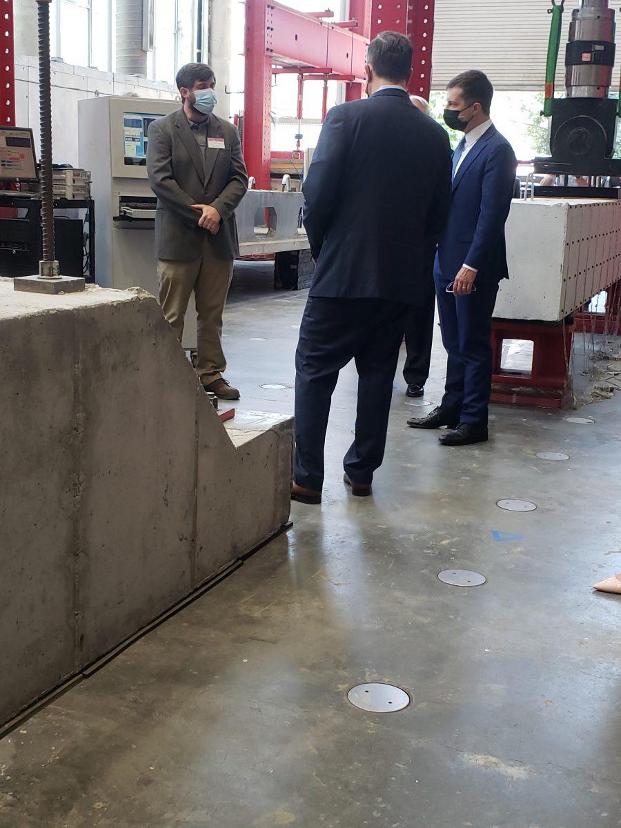 U.S. Secretary of Transportation Pete Buttigieg and second gentleman Doug Emhoff listen to a speaker at the Constructed Facilities Lab at Centennial Campus on April 30, 2021. Buttigieg and Emhoff toured NC State while in Raleigh to promote a transportation bill.