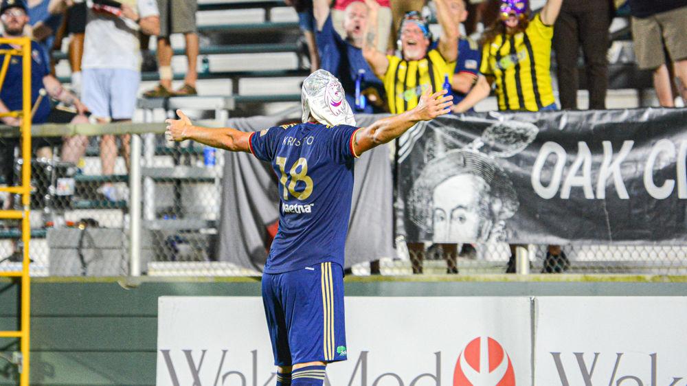 NCFC forward Robert Kristo celebrates a goal while wearing a supporter's mask on Saturday, Sept. 7 at WakeMed Soccer Park. Kristo scored two goals in the match that ended in a 3-3 draw.