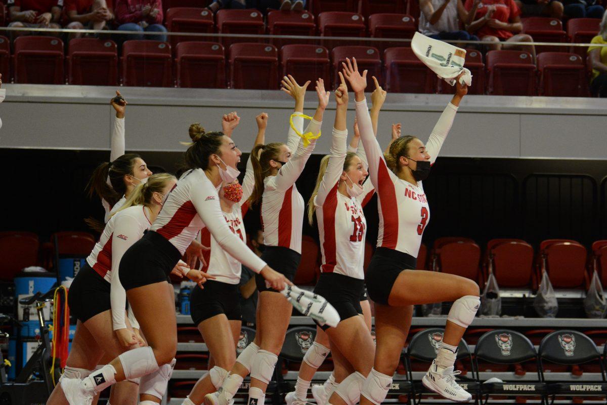 The NC State volleyball team celebrates their win against Wofford on Friday, Sep. 3., 2021 at Reynolds Coliseum. The Wolfpack won 3-0 against the Terriers.
