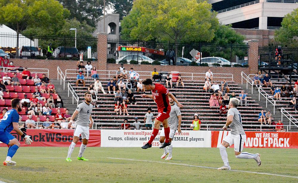 Freshman midfielder Yaniv Bazini heads in a goal during the NC State Wolfpack's soccer match against the UCF Knights at Dail Soccer Field on Monday, Sep. 6, 2021. The Wolfpack won the match 2-1.