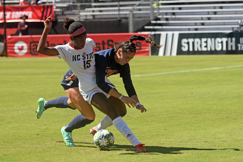 Sophomore forward Jameese Joseph fights for the ball against a Virginia defender on Sunday, Sept. 26, 2021 at Dail Soccer Field. NC State had 4 shots on goal but lost to Virginia 2-1.