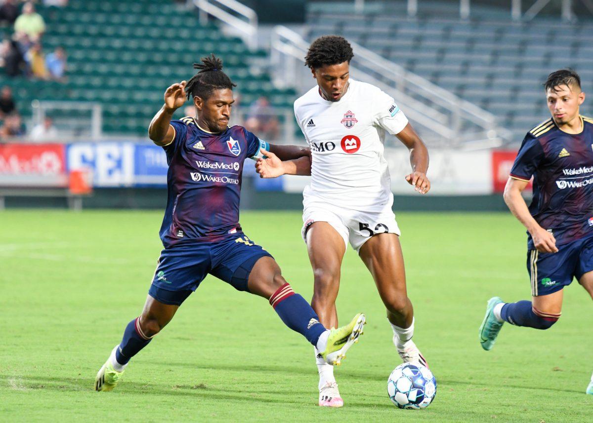 NCFC midfielder Peter Pearson attempts to steal possession of the ball during the game versus Toronto FC II on Sunday, July 18, 2021 in Sahlen's Stadium at WakeMed Soccer Park. NCFC lost to Toronto FC II 4-2.