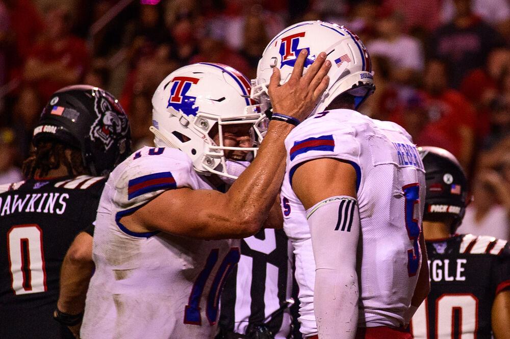 Louisiana Tech quarterback Austin Kendall (10) celebrates his touchdown pass to wide receiver Griffin Hebert (5) on Saturday, Oct. 2, 2021 at Carter-Finley Stadium. The Wolfpack won 34-27.
