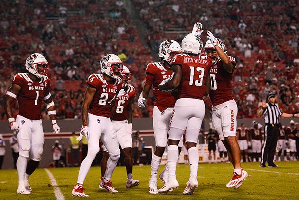 Six defensive players celebrate junior nickelback Tyler Baker Williams' interception during the game against Furman on Saturday, Sept. 18, 2021 at Carter-Finley Stadium. Baker-Williams gained seven yards on the play. The Wolfpack beat the Furman Paladins 45-7.