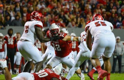 Sophomore linebacker Drake Thomas breaks through the offensive line against Louisville to get a tackle for loss on Oct. 30, 2021, at Carter-Finley Stadium, in Raleigh, North Carolina. Thomas led the NC State defense with two sacks and 2.5 tackles for loss in NC State's victory over Louisville, 28-13.&#160;&#160;