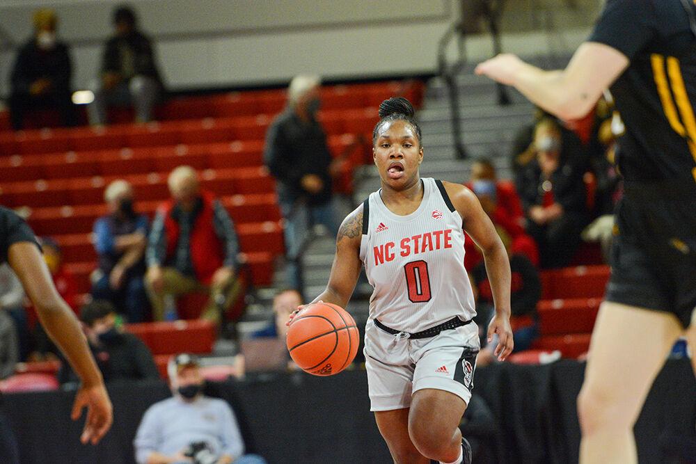 Sophomore guard Diamond Johnson dribbles the ball down the court during the game against Towson on Monday, Nov. 15, 2021 in Reynolds Coliseum. Johnson's 16 points helped lead the Pack to a 100-52 victory.