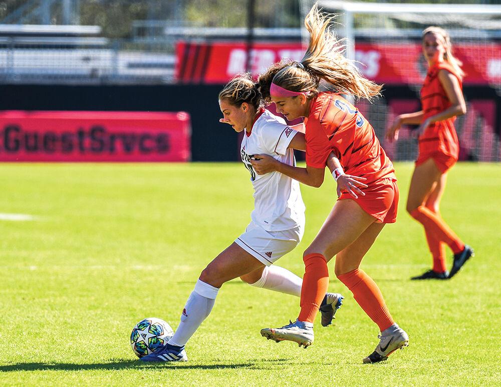 Freshman midfielder Annika Wohner fights to maintain possession of the ball during pressure from the Syracuse offense on Sunday, Oct. 24, 2021 in Dail Soccer Stadium. The Wolfpack beat Syracuse 3-0 in the Wolfpack's last home game of the season.