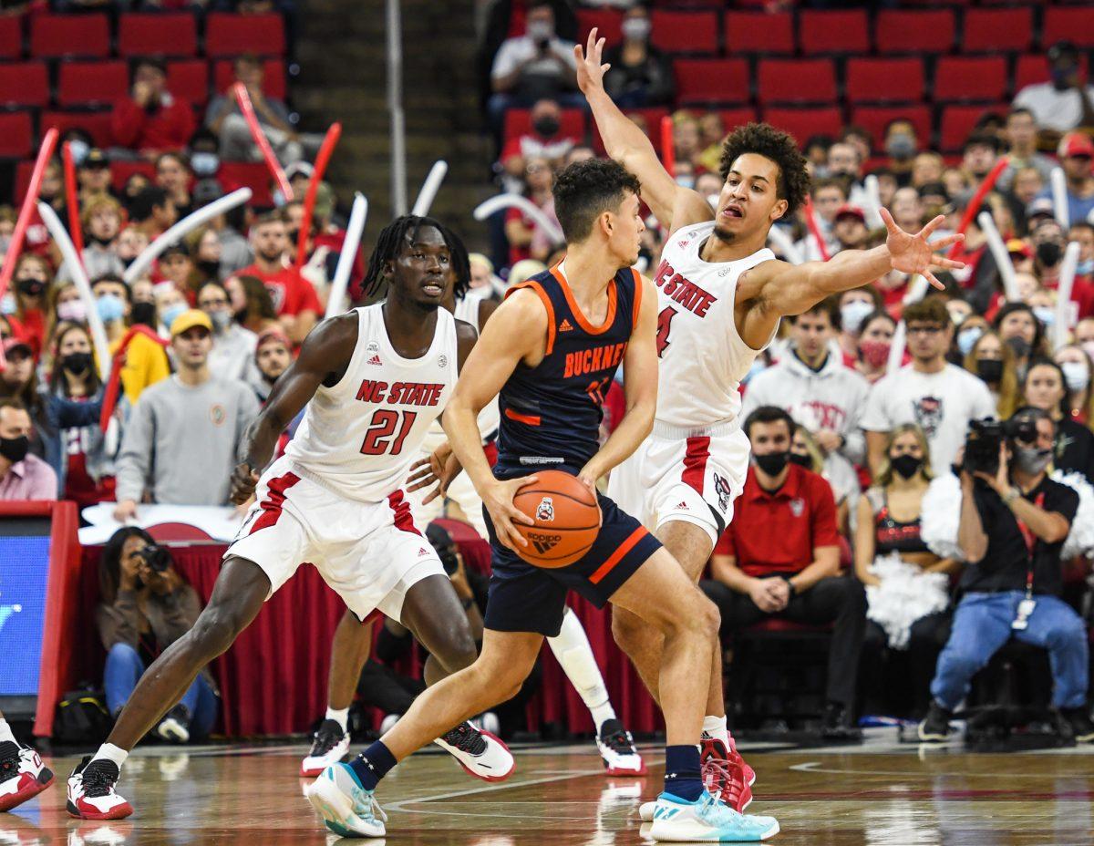 Senior forward Jericole Hellems jumps in front of the Bucknell offensive effort during the game on Tuesday, Nov. 9, 2021 in PNC Arena. Hellems was the Wolfpack's top scorer with 22 points against the Bucknell Bisons. The Wolfpack beat the Bisons 88-70.