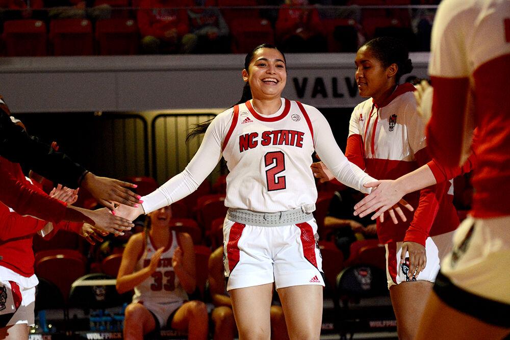 Graduate student guard Raina Perez is cheered on by her teammates at the beginning of NC State&#8217;s game against UNC Pembroke on Wednesday, Nov. 3, 2021 at Reynolds Coliseum. The Wolfpack beat the Braves 92-36.