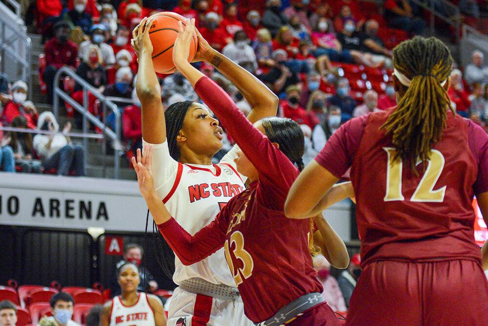 Junior forward Jada Boyd avoids losing the ball during the game against Elon on Sunday, Dec. 5, 2021 in Reynolds Coliseum. Boyd scored 17 points for the Wolfpack during the game. The Wolfpack pulled out a win against the Phoenix with a score of 78-46.