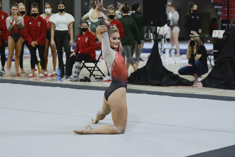 Graduate student gymnast Nicole Webb strikes a pose in her floor performance during the quad meet against New Hampshire, George Washington and William &amp; Mary in Reynolds Coliseum on Saturday, Jan. 29, 2022. The Wolfpack placed second place behind New Hampshire with a score of 195.250.