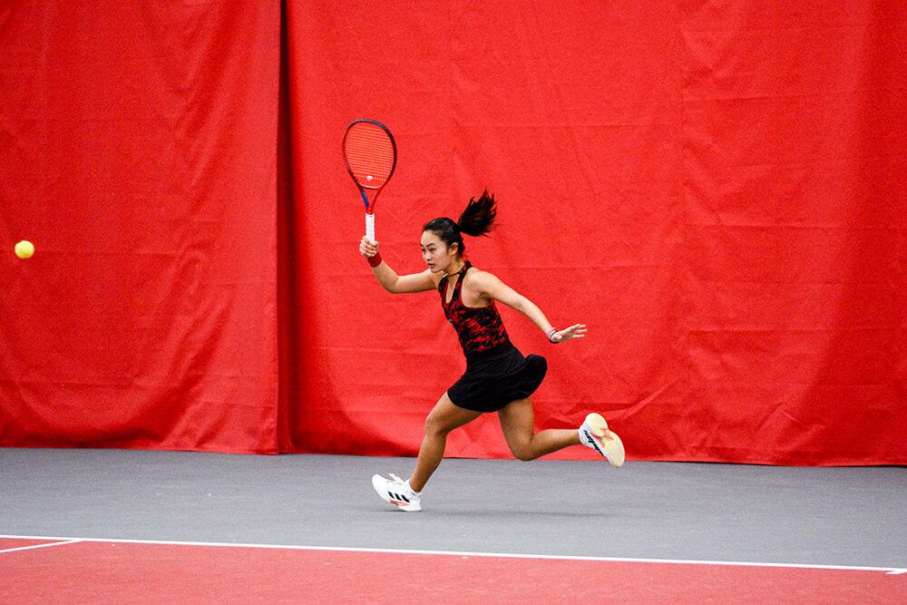 Freshman Priska Nugroho reaches to hit the ball at the tennis match against Penn State at J.W. Isenhour Tennis Center on Saturday, Jan. 29, 2022. The Wolfpack beat the Lions 4-0.