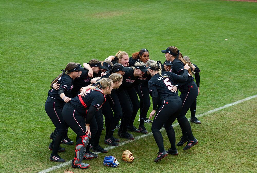 The team gets hype before the game against Bowling Green on Friday, Feb. 25, 2022 in Dail Softball Stadium. The Wolfpack beat the Falcons 4-0.