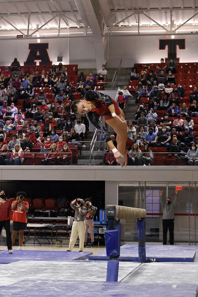 Junior gymnast Emily Shepard dismounts from the balance beam at the meet against UNC at Reynolds Coliseum on Saturday, Feb. 19, 2022. Shepard scored 9.875 on the event. NC State lost to UNC 196.625 to 196.350.
