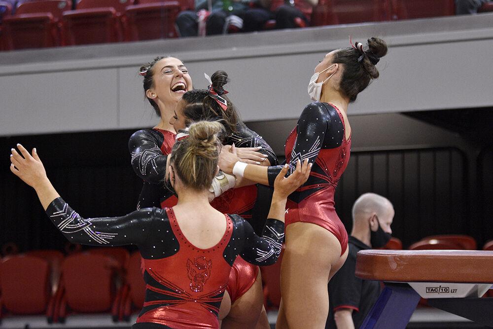 Freshman gymnast Lucy Lehman celebrates at the meet against UNC at Reynolds Coliseum on Saturday, Feb. 19, 2022. NC State lost to UNC 196.625 to 196.350.