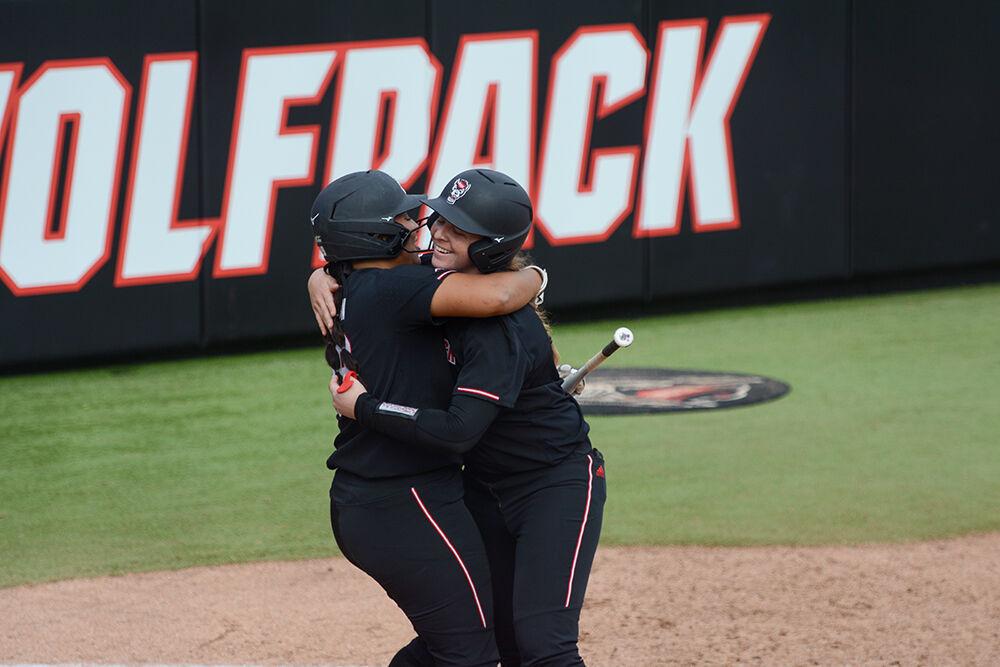 Graduate utility player celebrates with fifth year Sam Sack during the game against Bowling Green on Friday, Feb. 25, 2022 in Dail Softball Stadium. Johson and Sack both got homeruns during the Wolfpack's 4-0 win over the Falcons.