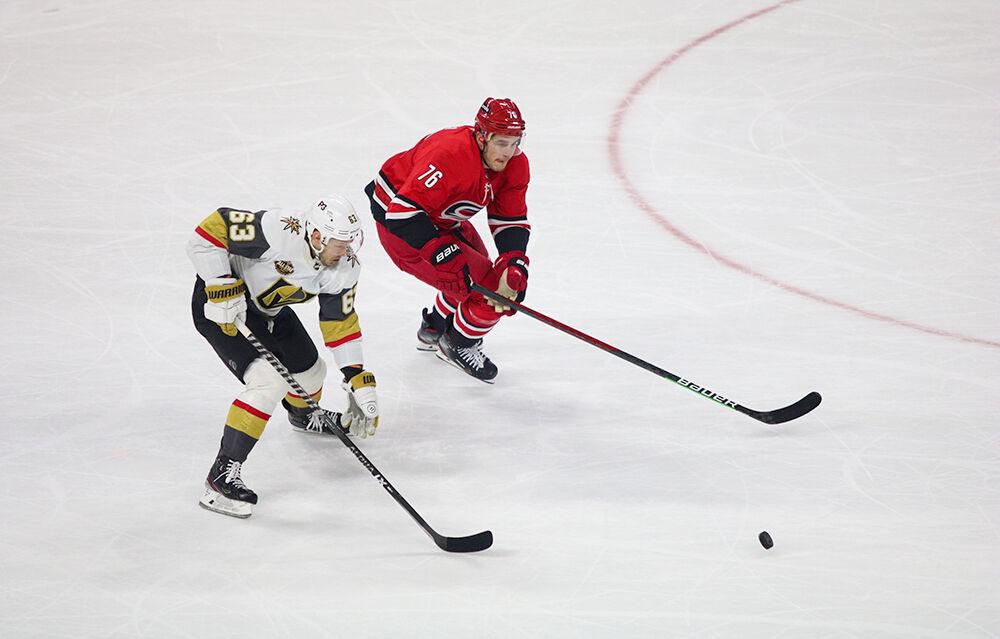 Left defenseman Brady Skjei fights for the puck with a Golden Knight opponent in PNC Arena on Tuesday, Jan. 25, 2022. Skjei had four shots in 24 shifts. The Hurricanes beat the Vegas Golden Knights 4-3.