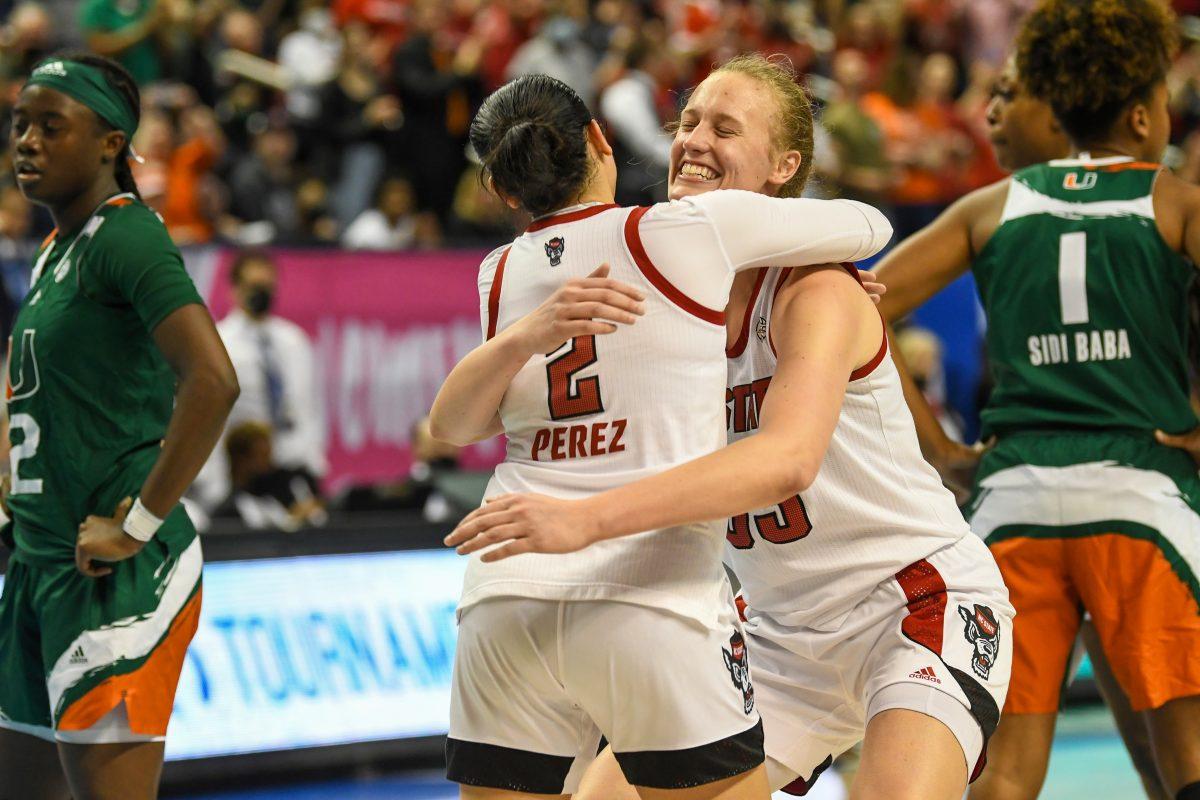 Senior center Elissa Cunane hugs graduate guard Raina Perez after the ACC championship game against the University of Miami on Sunday, March 6, 2022 inside Greensboro Coliseum. The Wolfpack won the game 60-47.