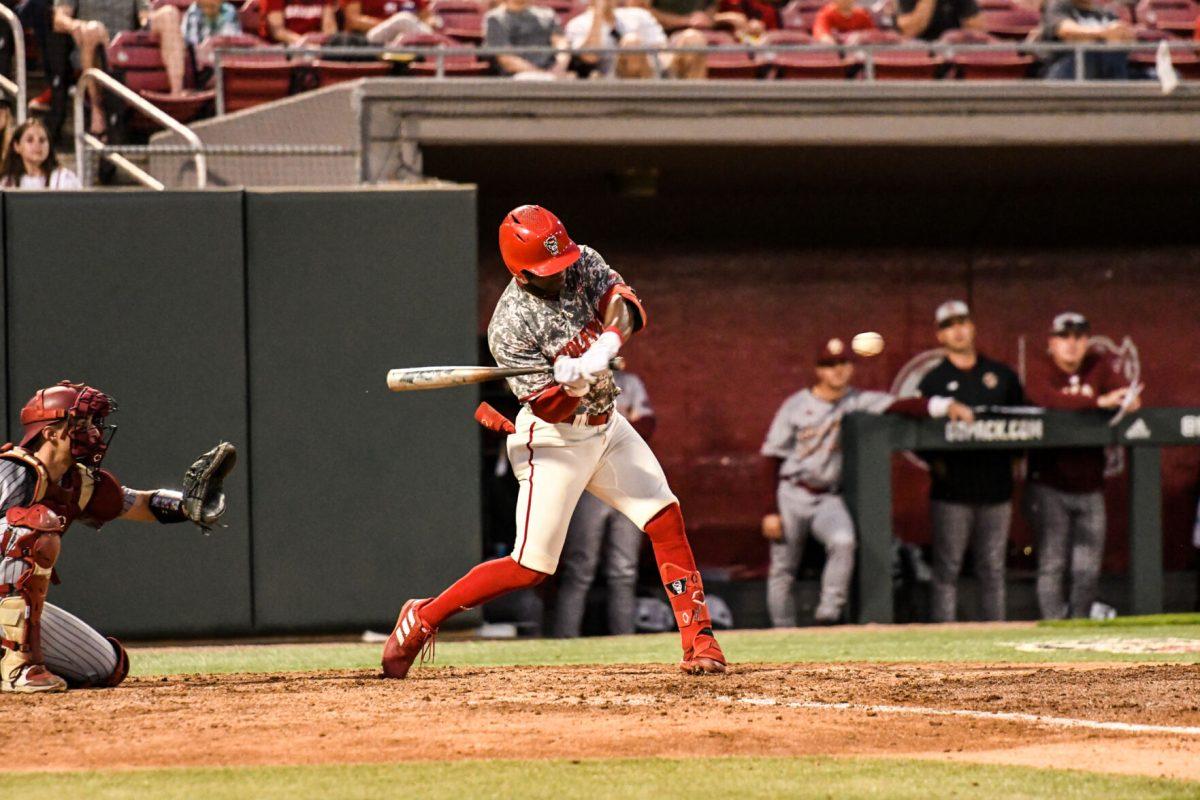 Senior outfielder Devonte Brown connects with the pitch during the game versus the Boston College Eagles on Thursday, April 14, 2022 in Doak Field at Dail Park. Brown had a walk off hit in the bottom of the 9th that led NC State to win against Boston College. The Wolfpack beat the Eagles 4-3.