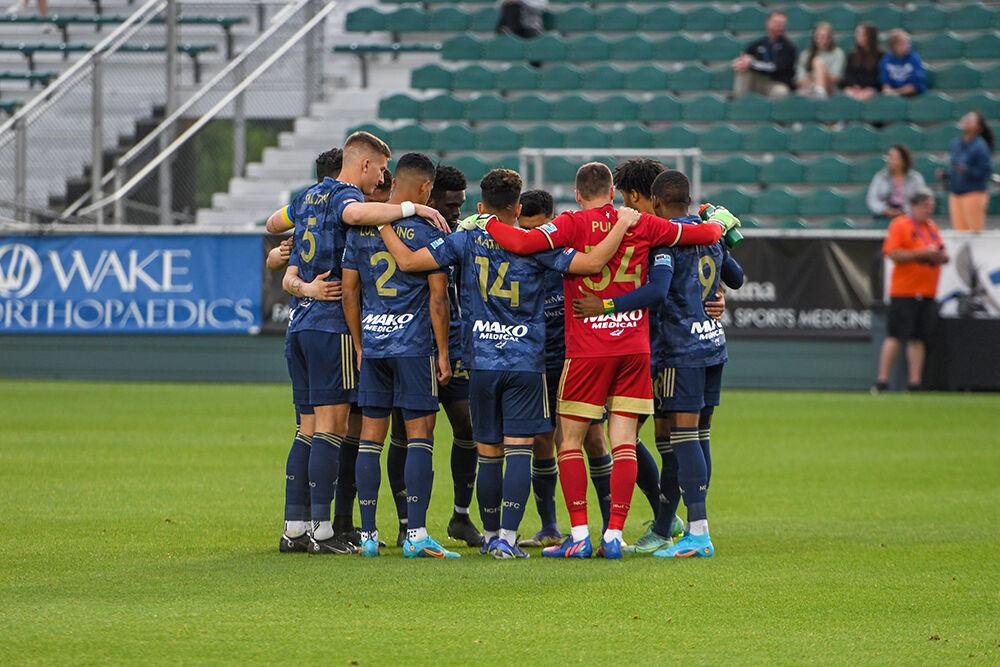 The NCFC starting lineup huddles before the game against the Northern Colorado Hailstorm on Saturday, April 30, 2022 in Sahlen's Stadium at WakeMed Soccer Park. NCFC suffered a loss to the Northern Colorado Hailstorm 2-1.