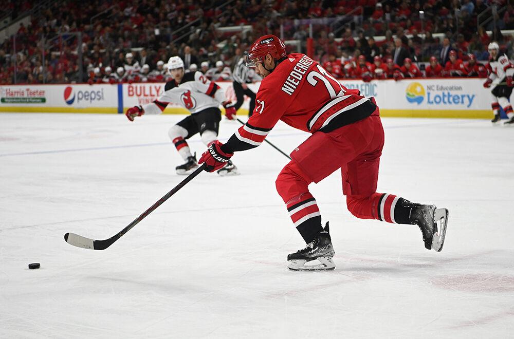 Right wing Nino Niederreiter takes the puck up thie ice during the game in PNC Arena on Thursday, April 28, 2022. The Hurricanes beat the Devils 6-3.