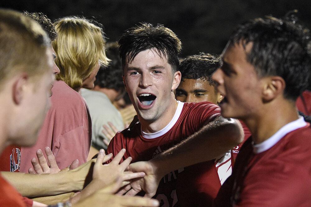 Graduate midfielder Conor Kelly celebrates winning the match against Loyola Maryland with the student section on Friday, Aug. 26, 2022 at Dail Soccer Field. Kelly scored one goal for the Wolfpack. NC State beat Loyola Maryland 2-0.