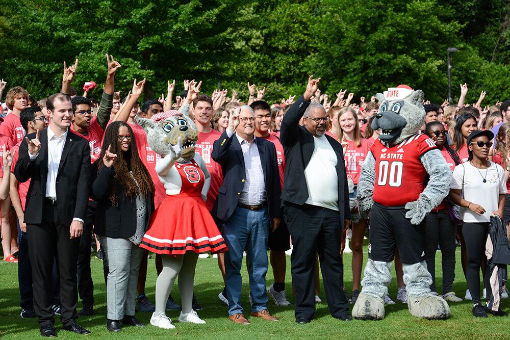 New Student Convocation speakers McKenzy Heavlin, Doneka Scott, Randy Woodson and Kofi Boone line up with Mr. and Mrs. Wuf and the class of 2026 at New Student Convocation for the 2026 class photo on Stafford Commons on Sunday, Aug. 21, 2022.