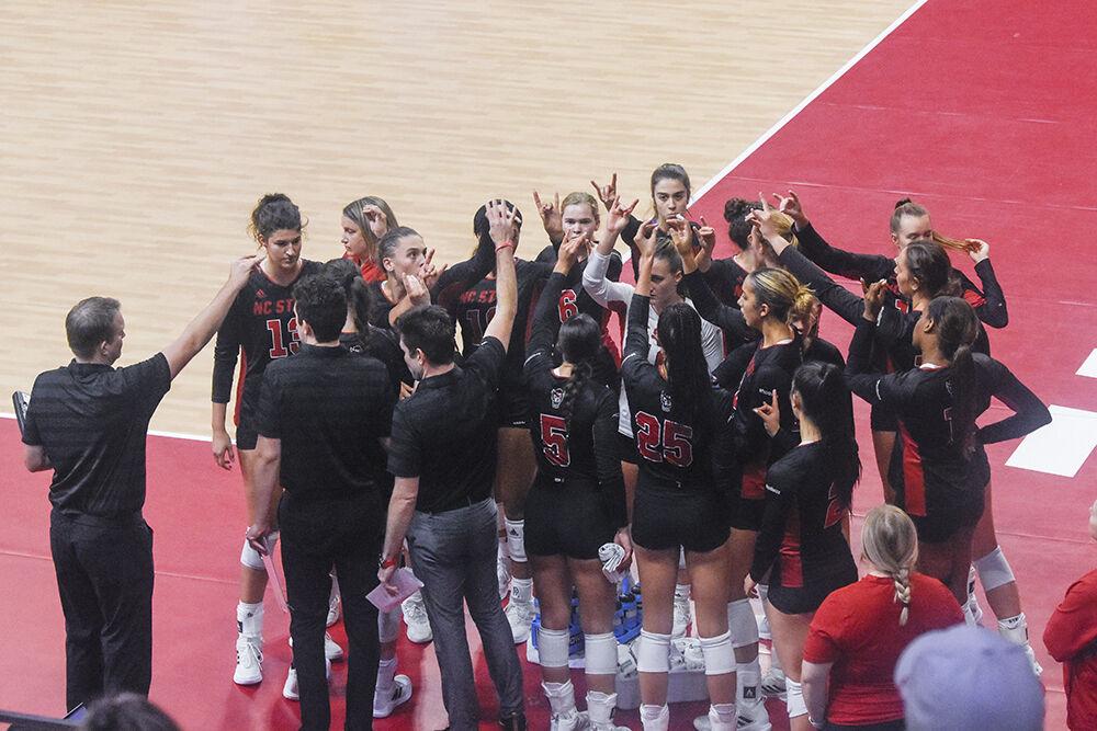 The North Carolina State University volleyball team throws up wolfies during a game against Western Carolina University on Friday, Sept. 9, 2022 in Reynolds Coliseum. The Wolfpack lost 3-0 against the Catamounts.
