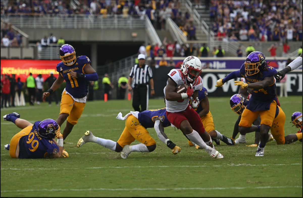 Sophomore running back Demi Sumo-Karngbaye breaks through several East Carolina tacklers during the Wolfpack's football game against the East Carolina Pirates at Dowdy-Ficklen Stadium on Saturday, Sept. 3, 2022. Sumo-Karngbaye ran for 79 yards on 14 carries as the Wolfpack beat the Pirates 21-20.&#160;&#160;