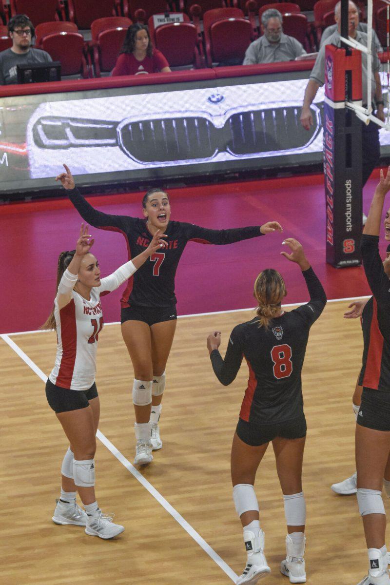 Graduate libero Priscilla Hernandez, freshman outside hitter Ava Brizard and junior setter Naomi Cabello celebrate a point during the game against Western Carolina University on Sept. 9, 2022 in Reynolds Coliseum. The Wolfpack lost 3-0 against the Catamounts.