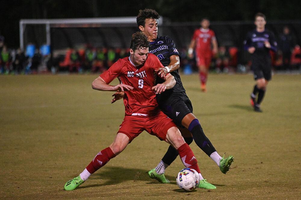 Sophomore forward Luke Hille attempts to keep possession of the ball during the match against High Point University on Tuesday, Oct. 4, 2022 at Dail Soccer Field. Hille attempted two shots on the goal for the Wolfpack. NC State beat High Point University 2-0.