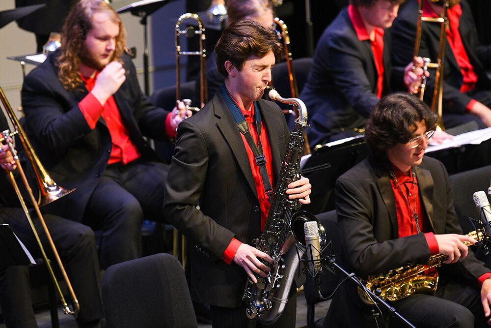 Garret Hitmar, a third-year studying industrial design, and lead tenor saxophone player, improvises a solo during the NC State Jazz Orchestra Fall Concert on Friday, Nov. 11, 2022 in Stewart Theatre.