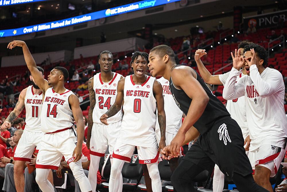 The NC State men's basketball bench celebrates senior guard Casey Morsell shooting a 3-pointer during the game against Florida International University on Tuesday, Nov. 15, 2022 in PNC Arena. Morsell scored 26 points and made six rebounds for the Wolfpack. NC State beat Florida International University 107-74.