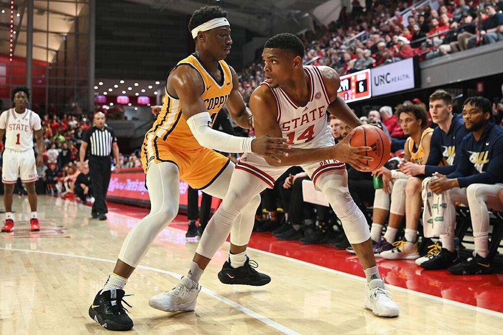Senior guard Casey Morsell prepares to drive the ball around an opponent during the annual Heritage Game against Coppin State in Reynolds Coliseum on Tuesday, Dec. 6, 2022. Morsell scored seven points and made five rebounds for the Wolfpack. NC State beat Coppin State 94-72.