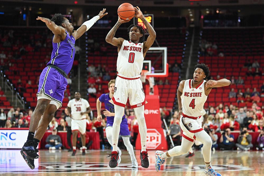 Sophomore guard Terquavion Smith shoots a 3-pointer during the game against Furman in PNC Arena on Tuesday, Dec. 13, 2022. Smith led in scoring with 24 points. NC State beat Furman 92-73.
