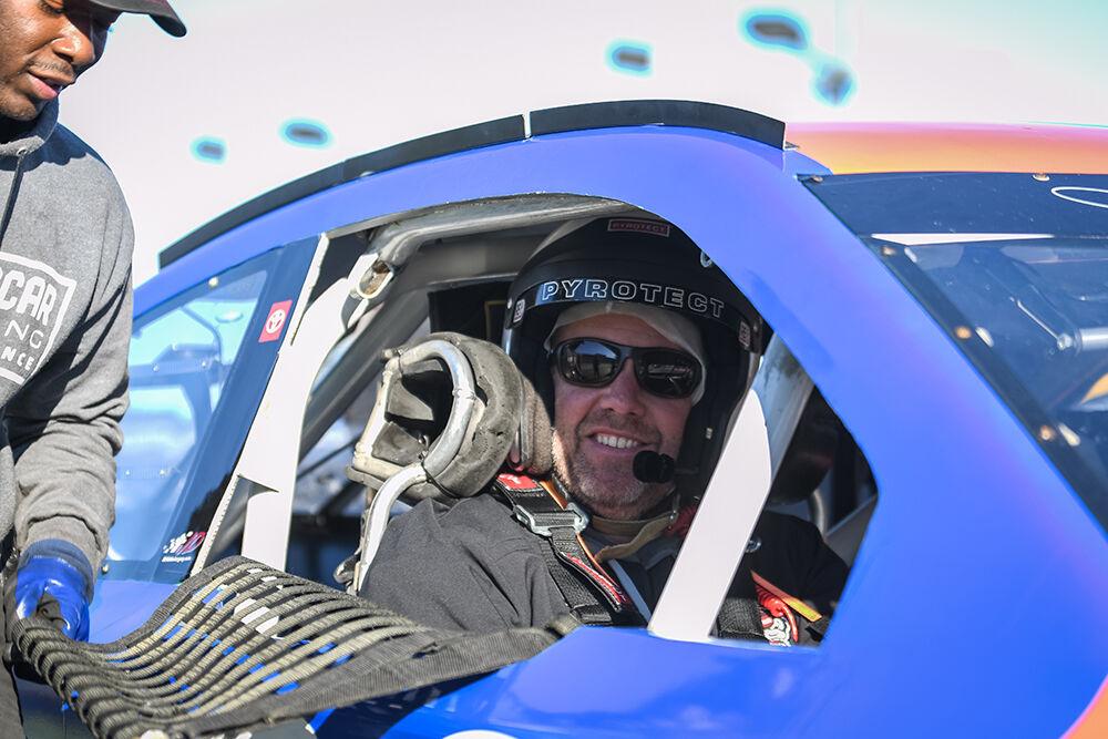 Head coach Dave Doeren sits in a stock car during the NC State football team's NASCAR Experience as a part of the Duke's Mayo Bowl week of events at Charlotte Motor Speedway&#160;on Tuesday, Dec. 27, 2022. The Wolfpack was selected to take on the University of Maryland Terrapins in the Duke's Mayo Bowl on Friday, Dec. 30, 2022 after the Wolfpack finished the regular season with an 8-4 record.